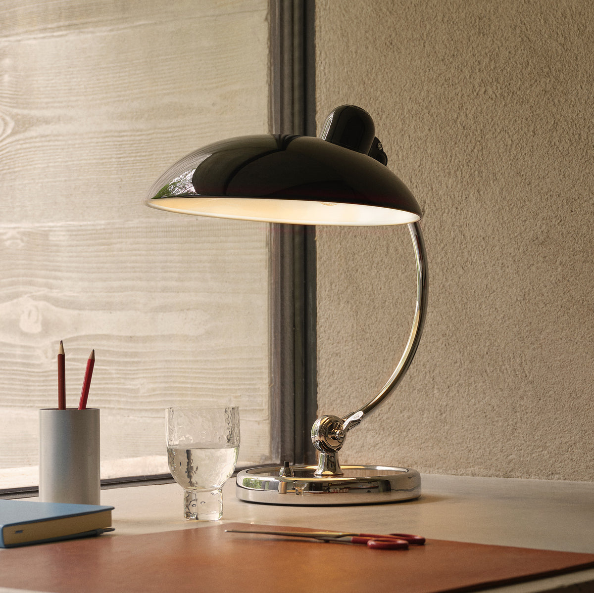 Birken Table Lamp in Black - Lit on a Desk by a Window
