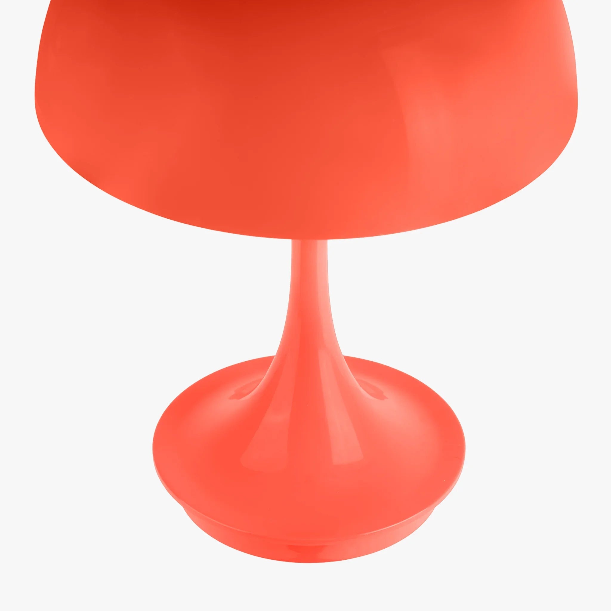 Vibrant coral table lamp with sleek tulip base, perfect for groovy modern decor