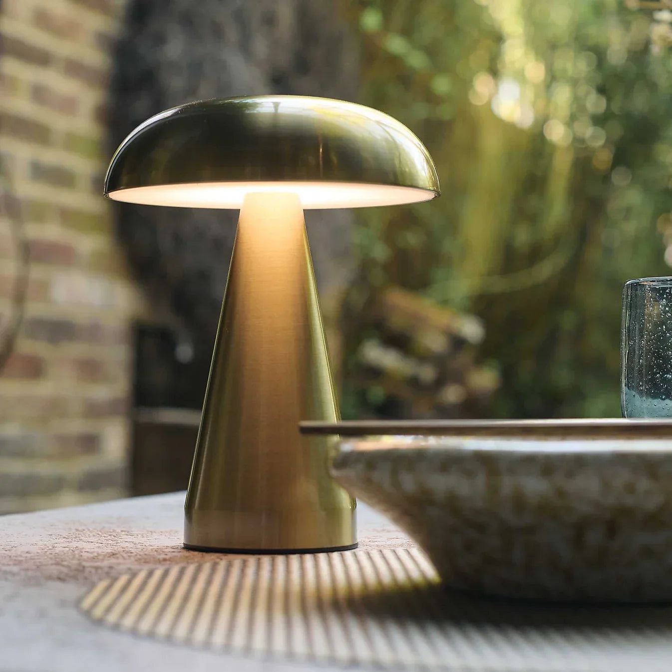 Modern gold mushroom table lamp with warm glow, perfect for cozy indoor spaces
