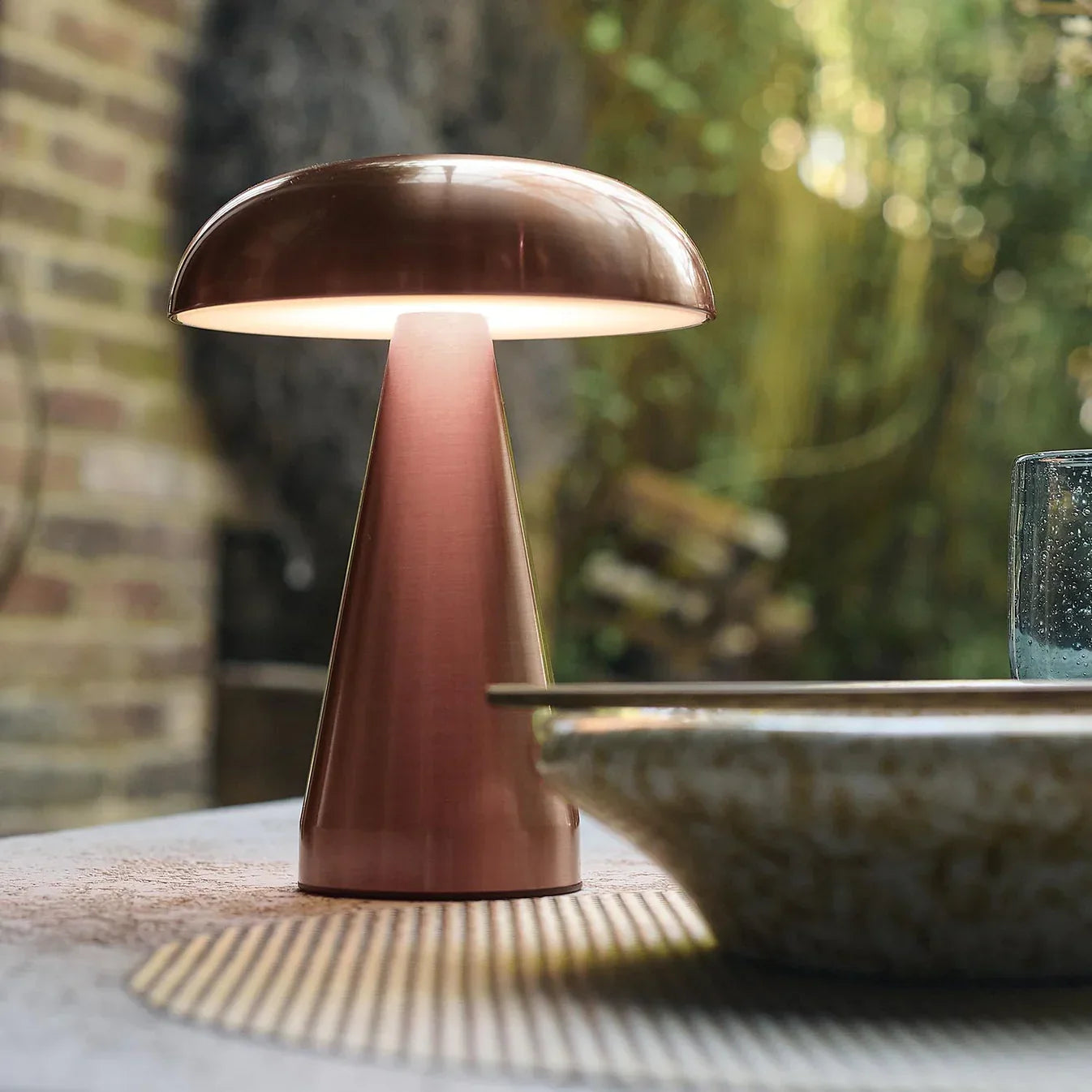 Copper mushroom table lamp with warm glow, perfect for cozy indoor or outdoor spaces