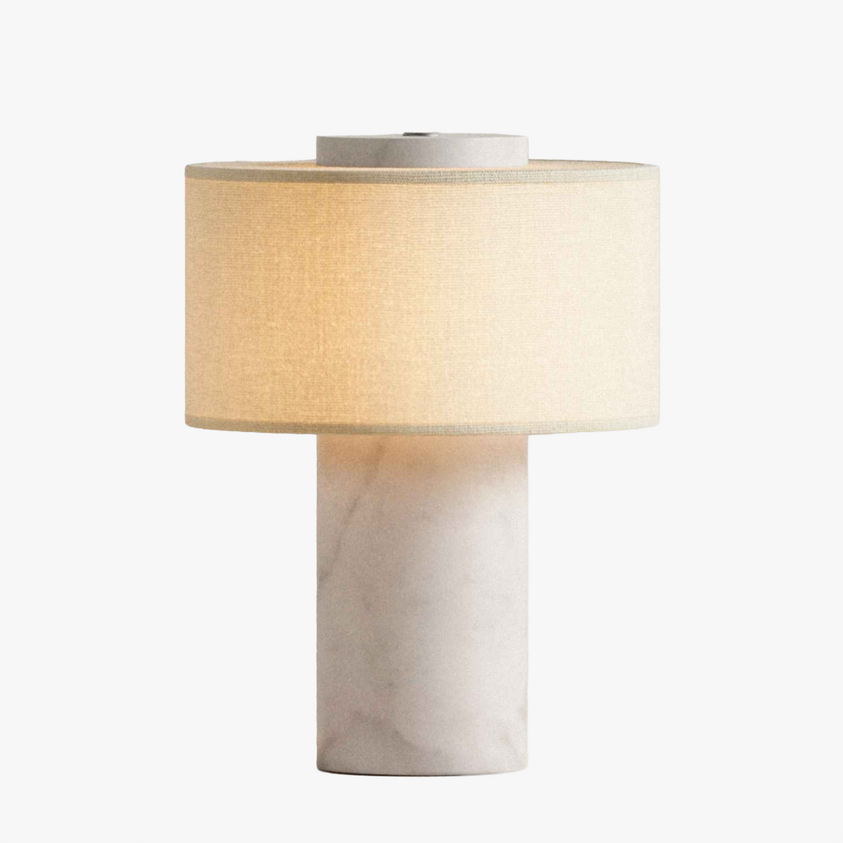 Olbia Portable Lamp in White Marble, a cordless marble table lamp with a fabric drum shade, light on, front view