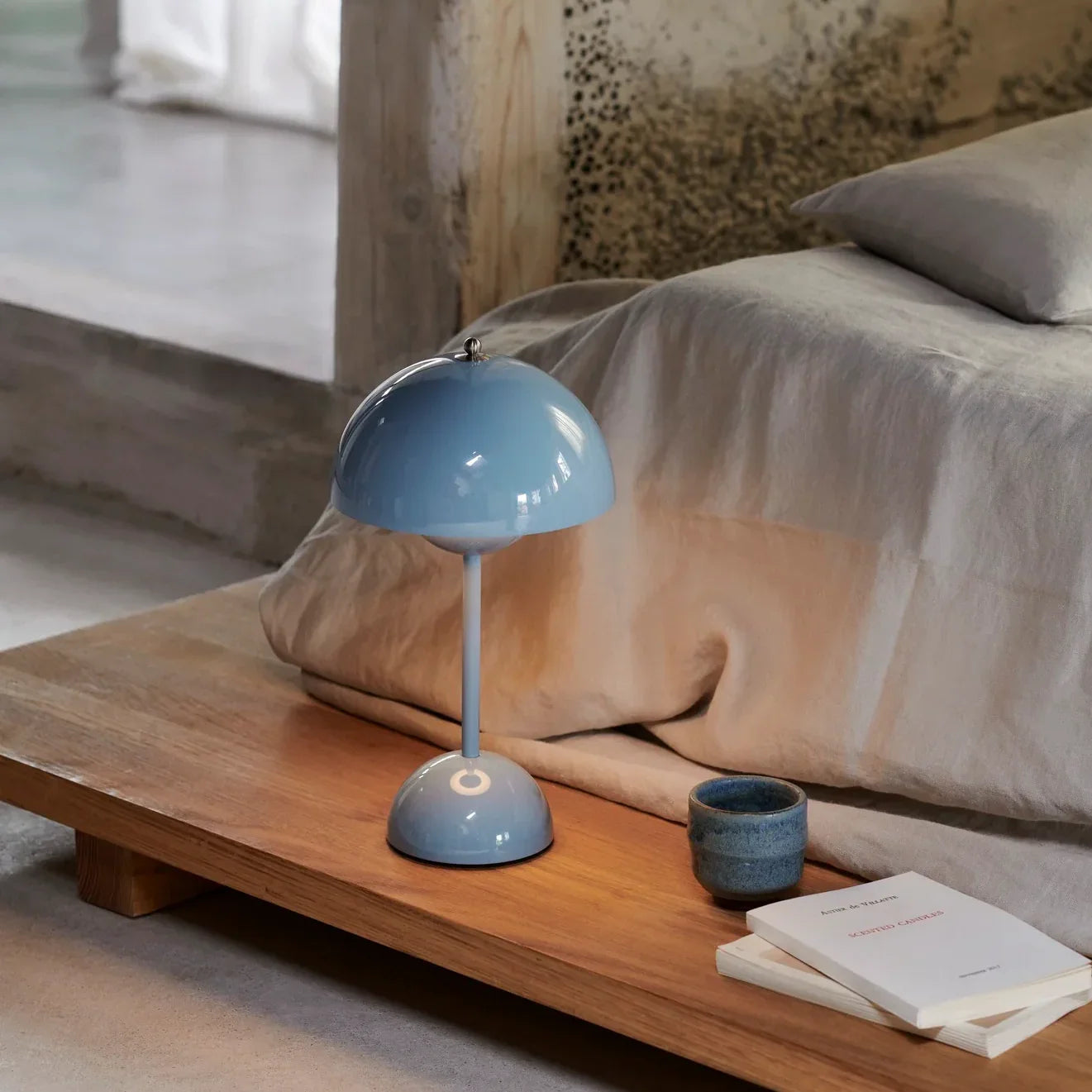 Groovy blue dome table lamp on wooden bedside table, perfect for cozy bedroom lighting