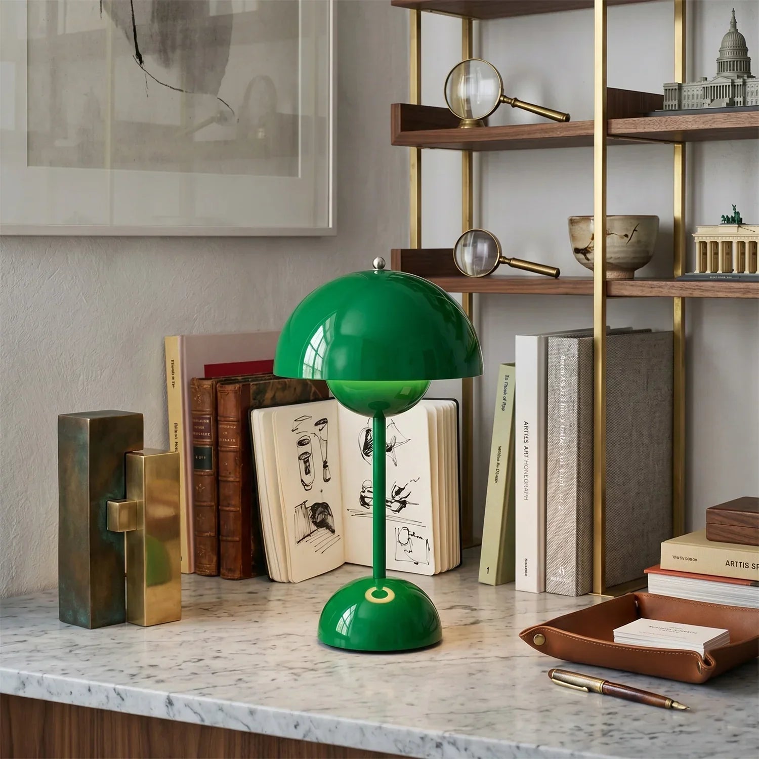 Green dome table lamp on marble desk with books and decor, funky home lighting