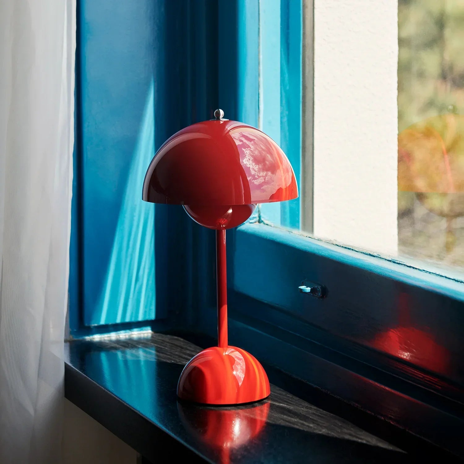 Groovy red dome table lamp on windowsill, funky mid-century modern lighting for cozy spaces