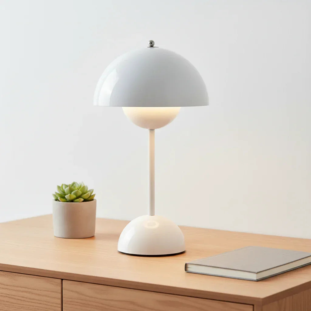 Modern white dome table lamp with sleek design on wooden desk, perfect for cozy ambient lighting